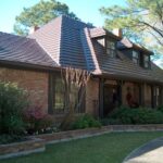 Brick house with dormer windows and garden