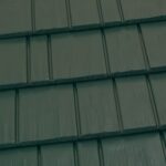 Green metal roof tiles close up view.