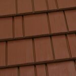 Brown metal roof tiles in overlapping pattern.