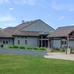 Modern blue house with wooden carport